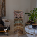 Aqua Onyx tower with its light off, revealing a polished stone top and layered blush, seafoam, and honey tones.