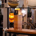 Decorative lamp with a wooden base on a table in a store setting
