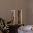 Unlit White Ice onyx cylinder lamp pair showing natural ivory, honey, taupe, and gray mineral patterning.