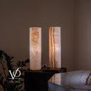 Illuminated side view of the White Ice onyx pair with a clouded mineral formation and glowing caramel ribboning.