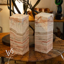 Two marble-textured lamps on a wooden table with a blurred indoor background.