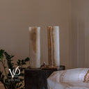 Unlit side view of the White Ice onyx table lamps showing their exact natural colors and organic mineral movement.