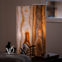 Detailed illuminated view of the White Ice onyx pair highlighting amber mineral formations and smoky banding.