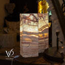 Marble-patterned lamp on a wooden surface with blurred background