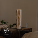 Unlit view of the same White Ice onyx lamp face showing ivory stone, honey formations, and smoky gray edging.