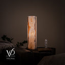 Illuminated reverse side of the White Ice onyx lamp with a broad clouded field of pearl, cream, and warm honey.