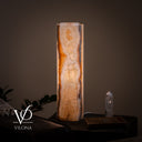 Close illuminated view of the lamp’s softer reverse face with clouded ivory onyx and warm amber edge lighting.