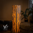 Illuminated 51-inch Exotic Golden Cloud onyx floor lamp with a cathedral-like central formation and glowing amber banding.
