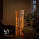Illuminated fourth face of the Exotic Golden Cloud onyx lamp with lace-like charcoal formations surrounded by warm golden light.