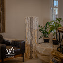 Unlit fourth face of the square onyx floor lamp revealing natural ivory, taupe, honey, and graphite mineral banding.