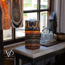 Close angled view of an illuminated Tangerine Onyx lamp showing translucent orange mineral bands
