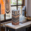 Angled view of a hand-carved Tangerine Onyx lamp made by Vilona family artisans