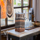 Illuminated Tangerine Onyx accent lamp with layered orange, brown, charcoal, and cream stone