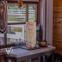 Bamboo Onyx table lamp Light Edition #1 displayed unlit beside a rustic window