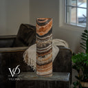 Unlit Tangerine Onyx cylinder table lamp with curved peach, ivory, and charcoal layers across its polished surface.