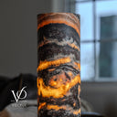 Close-up of the Tangerine Onyx lamp's upper rim and central swirl, with amber light between dark mineral bands.