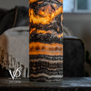 Close-up of the lamp's lower stone layers, showing glowing orange ribbons above fine charcoal and ivory banding.