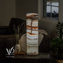 Light Tangerine Onyx lamp glowing with orange-tangerine bands and a natural vertical vein through the stone.