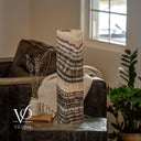 Unlit Tangerine Onyx table lamp showing diagonal gray-brown bands, ivory crystals, and pale apricot stone near the rim.