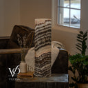 Unlit Tangerine Onyx table lamp revealing cream, peach, and gray-brown layers with a cord visible at the lower left.