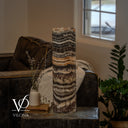 Unlit Tangerine Onyx cylinder lamp with cream and charcoal ripples, an apricot band, and brown marbling.