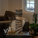 Unlit Tangerine Onyx table lamp showing a curved peach band above sweeping ivory and espresso-brown formations.