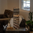 Unlit Tangerine Onyx cylinder lamp with ivory and brown marbling and a white inline on/off switch beside the base.
