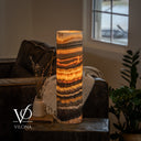 Glowing Tangerine Onyx table lamp with narrow orange seams above a broad honey-gold band and dark mottled lower layers.