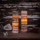 Tangerine Onyx table lamp pair illuminated from another side, revealing orange ribbons and honey-gold crystal bands.