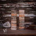 Unlit Tangerine Onyx lamp pair with a pale banded base on the left lamp and darker stone layers on the right.