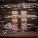 Rear view of unlit Tangerine Onyx lamps, with a broad ivory arch on the left lamp and curved cream banding on the right.