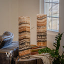 Unlit Tangerine Onyx lamp pair focused on the front lamp’s fine cream waves, peach bands and dark lower marbling.