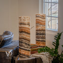 Unlit Tangerine Onyx lamp pair with the rear lamp in focus, revealing a diagonal pale vein and rich brown marbling.