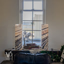 Matching unlit view of Tangerine Onyx lamps with pale ivory stone and diagonal charcoal and brown bands.