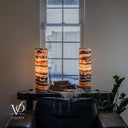 Illuminated Tangerine Onyx lamps with warm amber centers, curved dark upper bands, and the left lamp’s cord visible across its base.