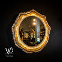 Round mirror with a natural wood frame on a dark background, featuring the brand 'Vilona'.