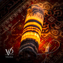 Hand carved banded onyx cylinder lamp by Vilona Onyx glowing warm amber on a patterned rug with inline cord switch