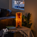 Handcrafted Aqua Onyx bedside lamp lit from within, showing rare translucent yellow -red patterns
