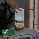 Illuminated White Ice Onyx table lamp glowing with natural white, ivory, and cream stone patterns