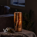Tangerine Onyx nightstand lamp glowing warmly, measuring 12 inches tall by 4.5 inches in diameter