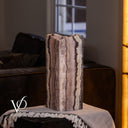 Unlit Rosa Onyx live-edge table lamp showing natural rose, cream, charcoal, and amber mineral banding