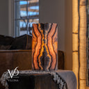 Vilona Onyx live-edge table lamp illuminated to reveal the natural translucency of Rosa Onyx