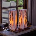 Vilona Onyx table lamp pair illuminated to showcase natural rose coloring and layered mineral banding