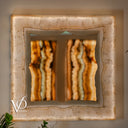 White Ice Onyx square mirror illuminated with soft warm light around a naturally sculpted inner live edge