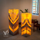 Miami Sunset Onyx floor lamp pair glowing with golden orange, amber, cream, and dark natural stone banding