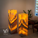 Luxury Miami Sunset Onyx lamps glowing warmly in a living room with sculptural natural stone patterns