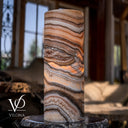 Sahara Onyx accent lamp glowing with rich cream, tan, caramel, and charcoal-brown stone banding