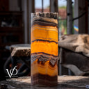 Miami Sunset Onyx bedside lamp glowing warmly with vivid yellow, rust red, and charcoal stone patterns