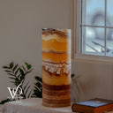Unlit Miami Sunset Onyx live-edge cylinder lamp showing natural orange, cream, rust red, brown, and charcoal banding