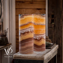 Matching Miami Sunset Onyx bedside lamps glowing warmly with sunset-inspired natural stone coloring